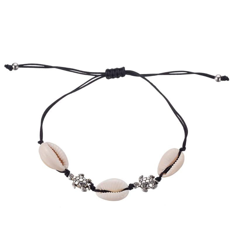Schwarzes Stoffarmband mit Muscheln und Schildkröten